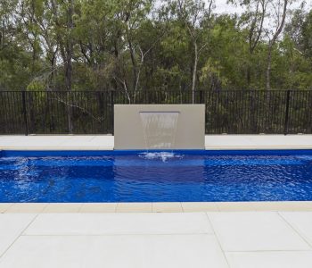 A lovely swimming pool with a water feature